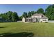 Large backyard featuring a well-maintained lawn, patio, and a screened-in porch at 5305 Yorkville Ct, Holly Springs, NC 27540