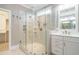 Bathroom featuring frameless glass shower, white vanity, and tiled floors at 5305 Yorkville Ct, Holly Springs, NC 27540