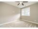 Light-filled bedroom featuring carpet, a ceiling fan, and a large window at 5305 Yorkville Ct, Holly Springs, NC 27540
