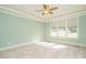 Bright bedroom with neutral paint, carpet, and large windows filling the room with natural light at 5305 Yorkville Ct, Holly Springs, NC 27540
