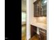Butler's pantry featuring granite countertop, wood cabinets, and designer backsplash at 5305 Yorkville Ct, Holly Springs, NC 27540