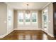 Dining area filled with natural light thanks to large windows and features beautiful hardwood floors at 5305 Yorkville Ct, Holly Springs, NC 27540