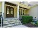 Close-up of the home's entryway featuring a beautiful wood door and stone steps at 5305 Yorkville Ct, Holly Springs, NC 27540