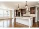 Open kitchen and breakfast area with custom cabinets, granite countertops and stainless appliances at 5305 Yorkville Ct, Holly Springs, NC 27540