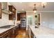 Gourmet kitchen featuring stainless appliances, granite counters, and custom cabinetry at 5305 Yorkville Ct, Holly Springs, NC 27540