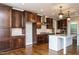 Spacious kitchen with dark wood cabinets, granite countertops, and stainless steel appliances at 5305 Yorkville Ct, Holly Springs, NC 27540