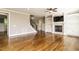 Spacious living room with fireplace, built-in shelving, and hardwood floors at 5305 Yorkville Ct, Holly Springs, NC 27540