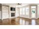Living room showcasing a fireplace, built-in shelving, and large windows at 5305 Yorkville Ct, Holly Springs, NC 27540