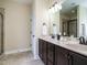 Modern bathroom featuring a double vanity, tiled floor and glass enclosed shower at 5400 Falconton Ln, Raleigh, NC 27610