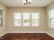 Dining room featuring hard wood floors, cream colored walls, and natural light at 5400 Falconton Ln, Raleigh, NC 27610