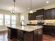 Kitchen featuring dark cabinets and granite countertops at 5400 Falconton Ln, Raleigh, NC 27610
