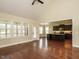 Living room space adjacent to kitchen featuring lots of natural light and hard wood floors at 5400 Falconton Ln, Raleigh, NC 27610