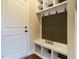 Mudroom with a storage bench, coat hooks, and a white door at 5400 Falconton Ln, Raleigh, NC 27610