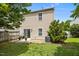 Backyard featuring a small patio, grassy area, privacy fence, and an air conditioning unit at 5561 Roan Mountain Pl, Raleigh, NC 27613