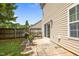 Cozy backyard patio with greenery, flower pots, and a view of the fenced yard at 5561 Roan Mountain Pl, Raleigh, NC 27613