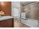 Bathroom featuring a tub, shower with sliding glass doors, and sink with wood cabinetry at 5561 Roan Mountain Pl, Raleigh, NC 27613