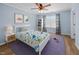Bright bedroom with a ceiling fan, dinosaur-themed decor, and a comfortable white bed frame at 5561 Roan Mountain Pl, Raleigh, NC 27613