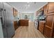 Spacious kitchen with wood cabinets, stainless steel appliances, and tiled backsplash at 5561 Roan Mountain Pl, Raleigh, NC 27613