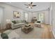 Inviting living room with a neutral color palette, plush seating, and lots of natural light at 5561 Roan Mountain Pl, Raleigh, NC 27613