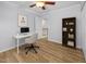 Home office space with desk, chair, shelving unit, and wood-look flooring at 5561 Roan Mountain Pl, Raleigh, NC 27613