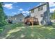 Spacious backyard featuring well-maintained grass and a wooden deck, perfect for outdoor enjoyment and entertaining at 5617 Tealbrook Dr, Raleigh, NC 27610