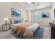 Bedroom with stylish decor, large bed, window view, neutral walls, and complementary artwork at 5617 Tealbrook Dr, Raleigh, NC 27610
