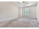 Bright bedroom with a ceiling fan, window, neutral walls, and carpet flooring ready for personalization at 5617 Tealbrook Dr, Raleigh, NC 27610