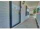 Inviting front porch with a glass door, neutral siding, and classic lighting, offering a warm welcome at 5617 Tealbrook Dr, Raleigh, NC 27610