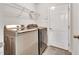 Laundry room featuring stainless steel washer, dryer, and wire shelving at 5617 Tealbrook Dr, Raleigh, NC 27610