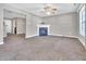 Cozy living room featuring a fireplace, neutral walls and ample natural light at 5617 Tealbrook Dr, Raleigh, NC 27610