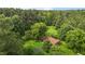Scenic aerial view of a secluded home nestled amidst lush greenery and towering trees at 5918 Efland Cedar Grove Rd, Cedar Grove, NC 27231