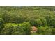 Secluded home nestled amidst a sea of lush greenery and towering trees at 5918 Efland Cedar Grove Rd, Cedar Grove, NC 27231