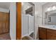 Bathroom featuring a vanity and a peek into the shower with saloon doors at 5918 Efland Cedar Grove Rd, Cedar Grove, NC 27231