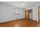 Bedroom featuring hardwood floors, ceiling fan, a window, and a closet at 5918 Efland Cedar Grove Rd, Cedar Grove, NC 27231