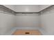 Empty walk-in closet featuring shelving with wooden closet poles at 5918 Efland Cedar Grove Rd, Cedar Grove, NC 27231