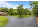 Expansive driveway leading to a charming home surrounded by green lawns and mature trees at 5918 Efland Cedar Grove Rd, Cedar Grove, NC 27231
