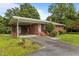 Brick ranch home with a covered carport and a well-maintained front yard at 5918 Efland Cedar Grove Rd, Cedar Grove, NC 27231