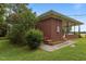 Charming brick home featuring a cozy covered porch and blossoming shrubs in the front yard at 5918 Efland Cedar Grove Rd, Cedar Grove, NC 27231