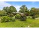 Charming brick ranch home featuring mature landscaping and a well-maintained front yard at 5918 Efland Cedar Grove Rd, Cedar Grove, NC 27231