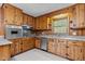 Eat-in Kitchen with knotty pine cabinetry, stainless appliances, & tile flooring at 5918 Efland Cedar Grove Rd, Cedar Grove, NC 27231