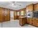 Eat-in Kitchen with knotty pine cabinetry, stainless appliances, & tile flooring at 5918 Efland Cedar Grove Rd, Cedar Grove, NC 27231