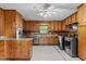 Eat-in Kitchen with knotty pine cabinetry, stainless appliances, & tile flooring at 5918 Efland Cedar Grove Rd, Cedar Grove, NC 27231