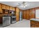 Eat-in Kitchen with knotty pine cabinetry, stainless appliances, & tile flooring at 5918 Efland Cedar Grove Rd, Cedar Grove, NC 27231
