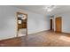 Spacious living room featuring hardwood floors, ceiling fan, and access to the kitchen at 5918 Efland Cedar Grove Rd, Cedar Grove, NC 27231