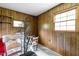 Wood-paneled room with furniture and two windows at 5918 Efland Cedar Grove Rd, Cedar Grove, NC 27231