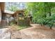 Exterior of home featuring a deck, sunroom, and landscaping in a serene wooded setting at 6 Womble Cir, Durham, NC 27705