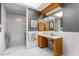 Tiled bathroom with glass shower, wood vanity, and decorative wallpaper exudes retro charm at 6 Womble Cir, Durham, NC 27705