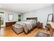 Bright bedroom features hardwood floors, a comfortable bed, and tasteful decor at 6 Womble Cir, Durham, NC 27705