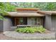 Inviting front entrance features a wooden door and a small porch with brick accents at 6 Womble Cir, Durham, NC 27705