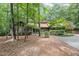 Charming single-story home with a wooded front yard and a concrete driveway at 6 Womble Cir, Durham, NC 27705